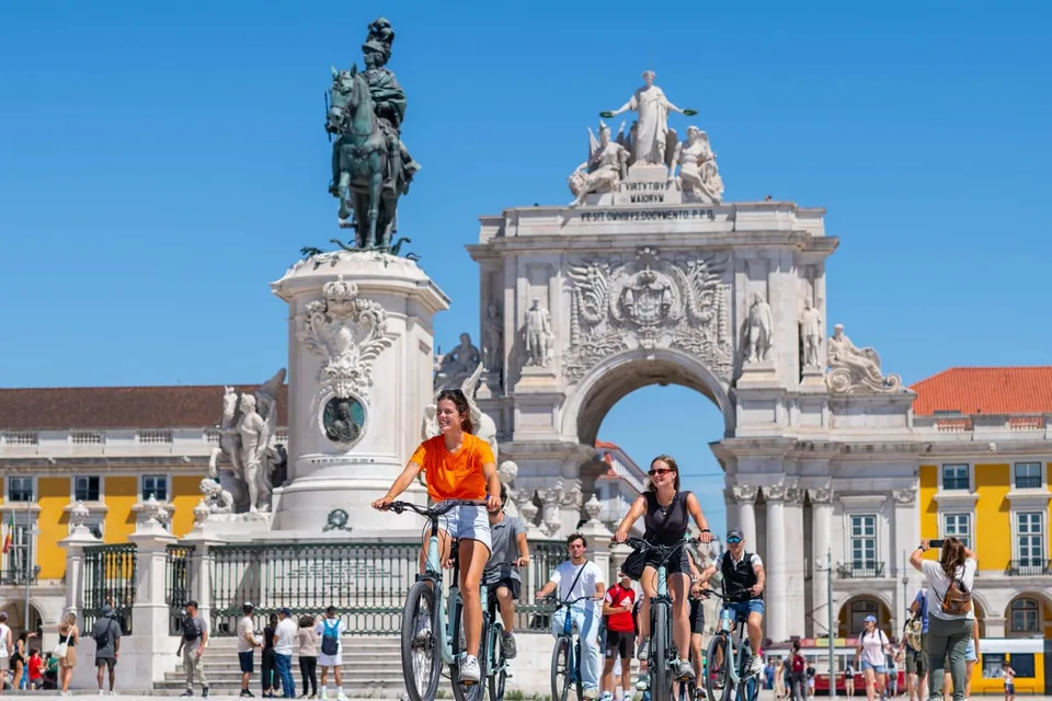 A grand riverside square with a triumphal arch